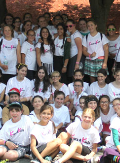 A very large group of girls wearing Kars4Kids teeshirts pose for a picture
